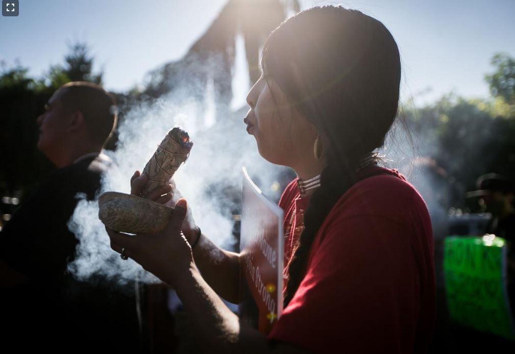 Gabrielle Colfax burns sage during a prayer walk dedicated to missing and murdered Indigenous people Wednesday, July 14, 2021, on South Camas Avenue in Wapato, Wash.

Amanda Ray / Yakima Herald-Republic